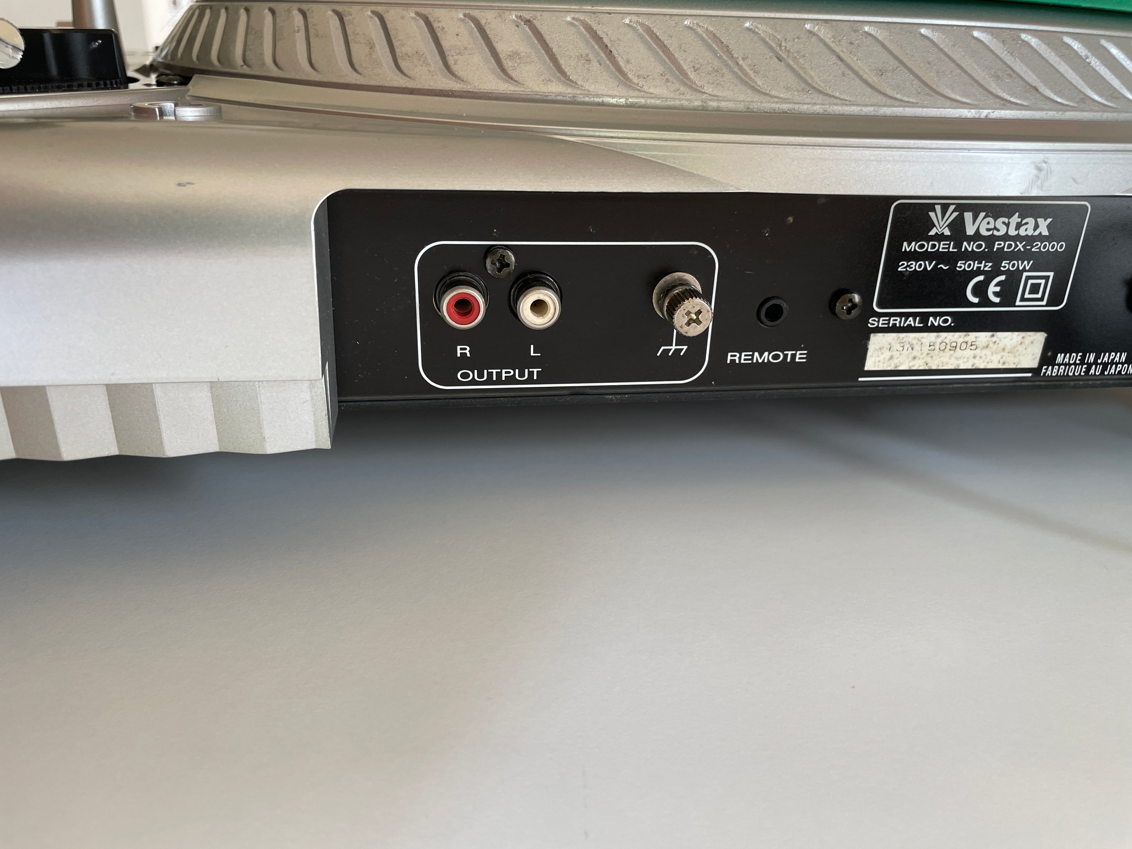 Close-up of the rear output panel of a Vestax turntable, showing red and white RCA jacks, a remote switch, and the Vestax model label.