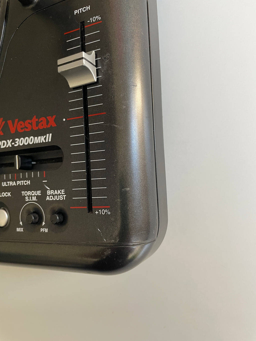 Close-up of a black Vestax DX-3000MKII pitch adjuster pedal with red and white markings, showing the pitch slider and control labels.