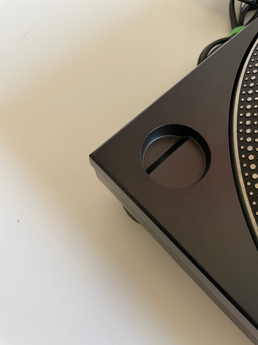 Close-up of a black electronic device on a light surface