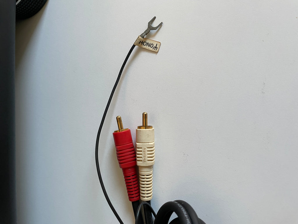 Audio cable with red and white plugs on a white background