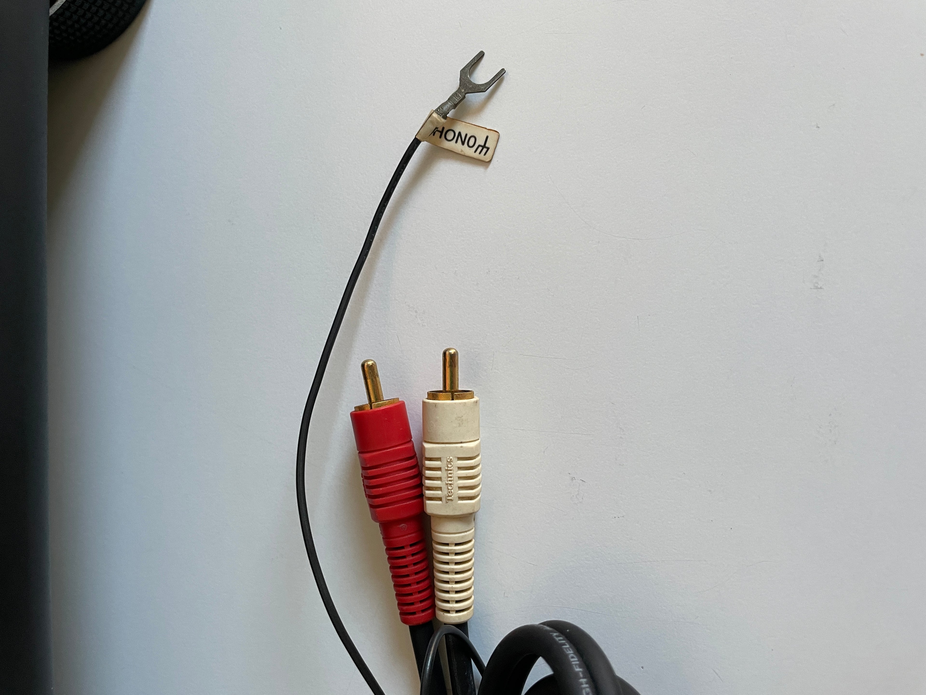 Audio cable with red and white plugs on a white background