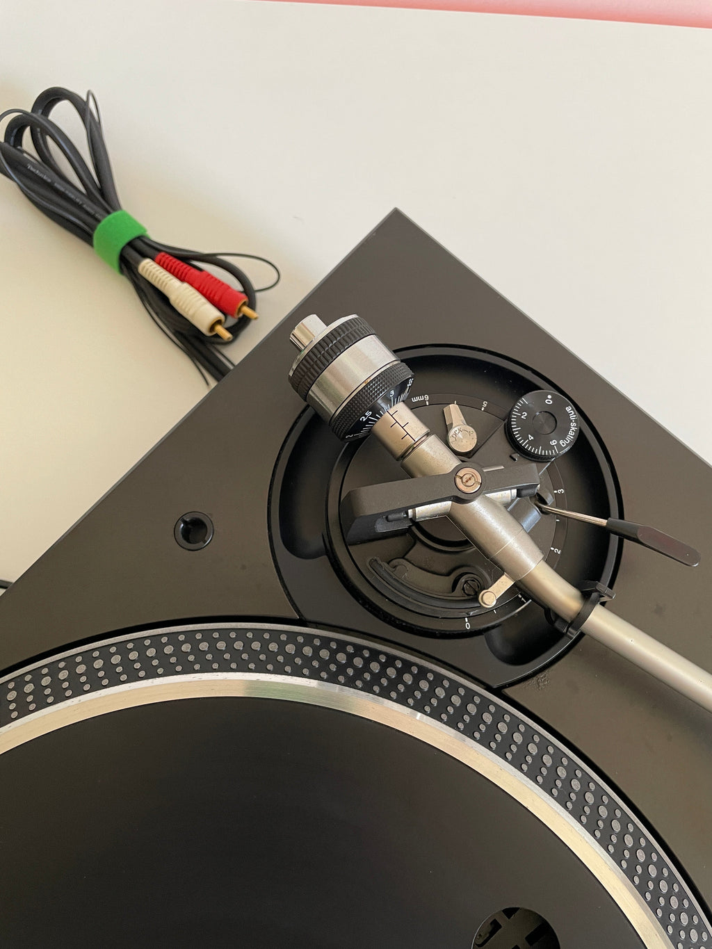 Close-up of a turntable with a cable on a white background