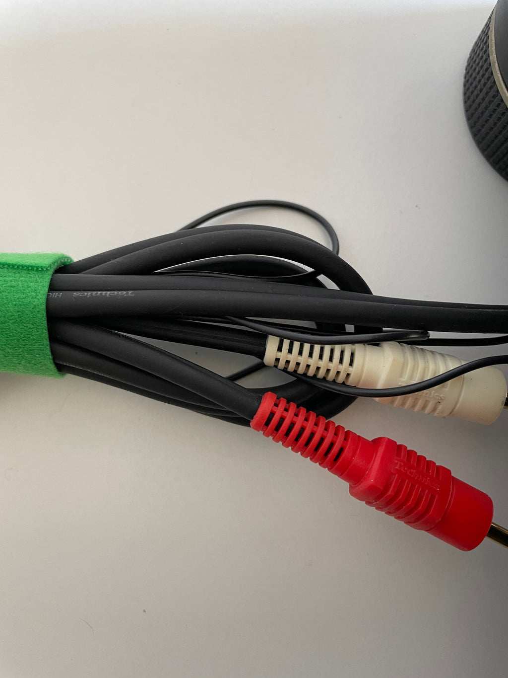 Cable with red, black, and white connectors on a white background