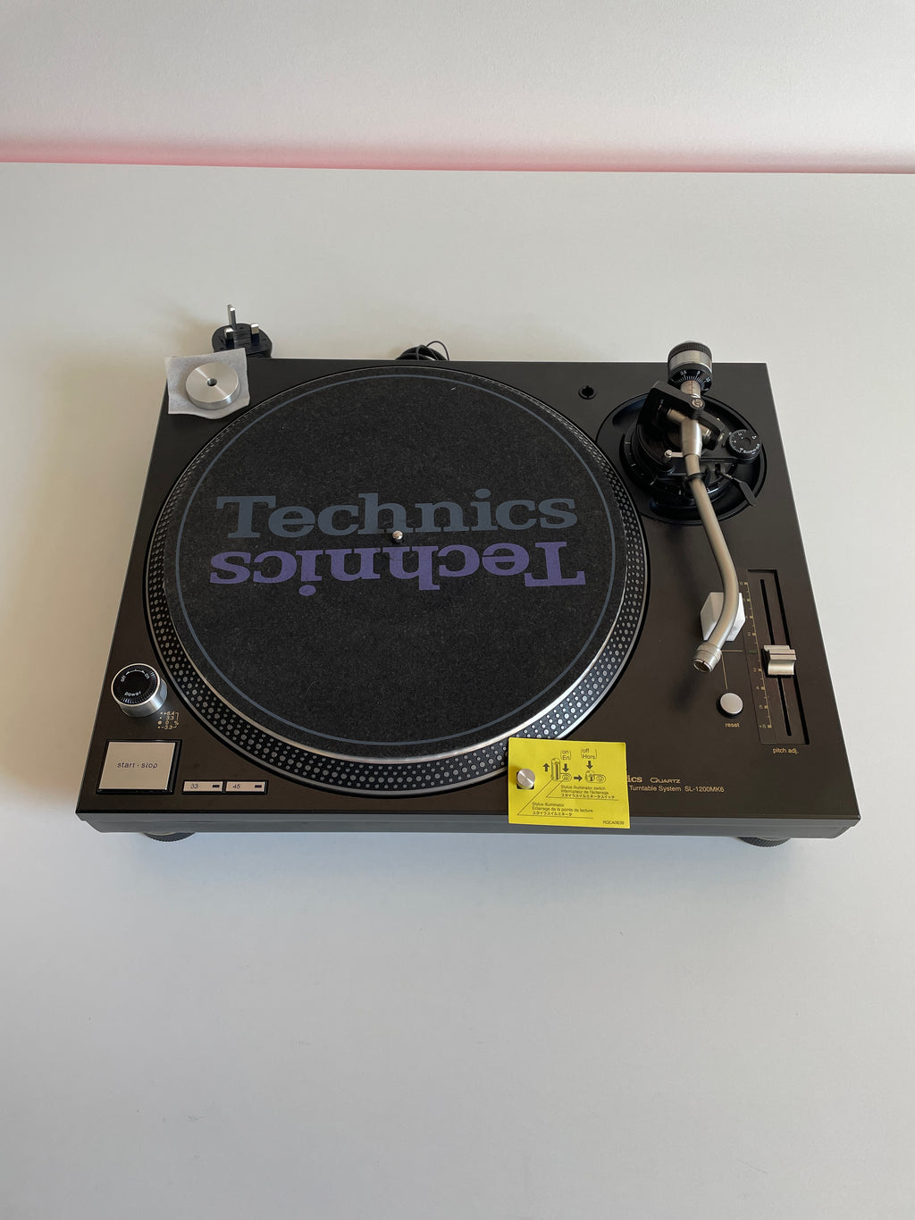 Technics turntable on a white wall
