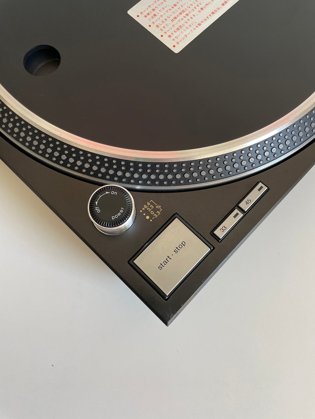 Close-up of a turntable with a white background
