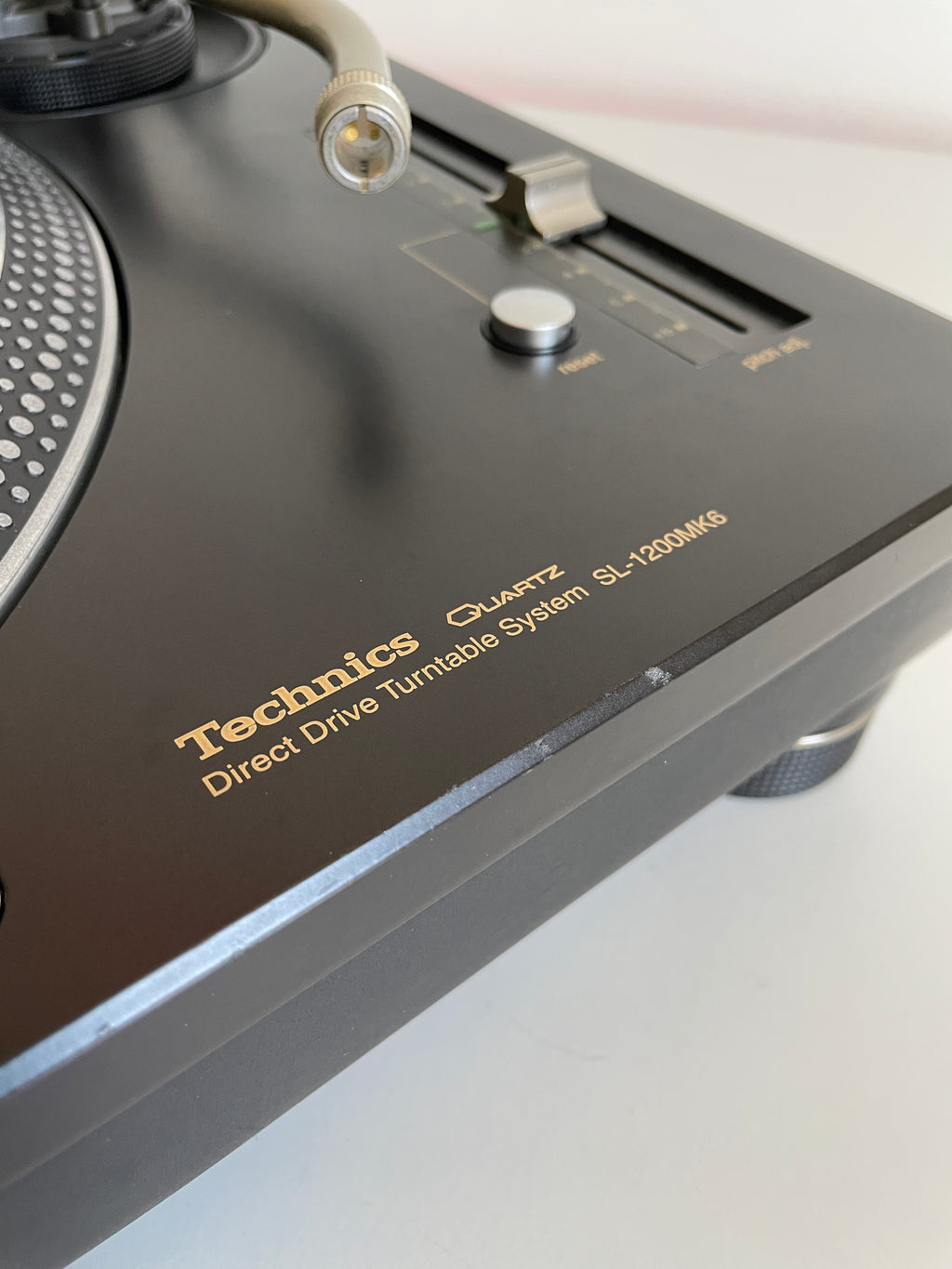 Close-up of a Technics audio device with visible branding on a white background