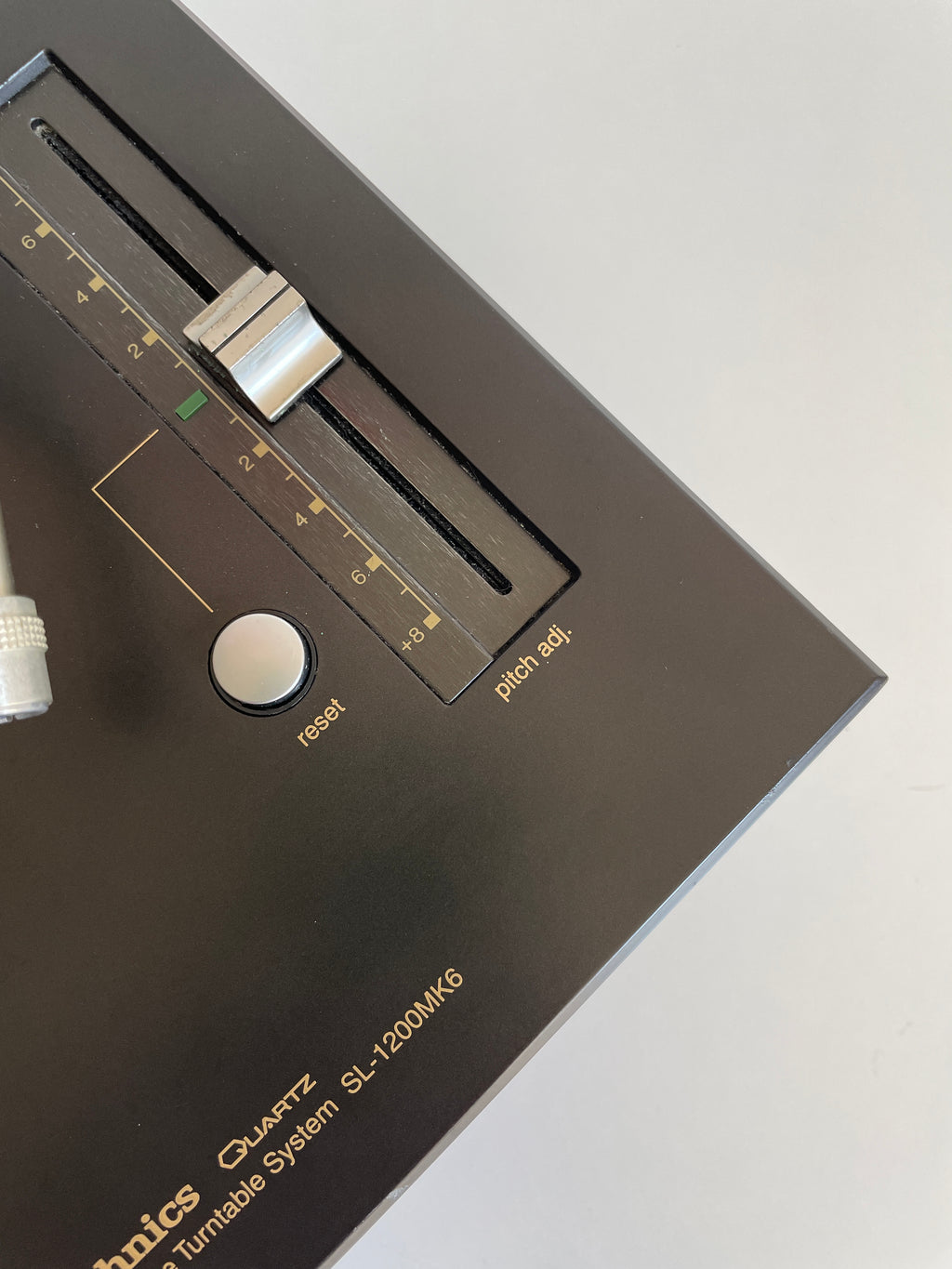 Close-up of a vintage audio equipment component with brand name on a light gray background