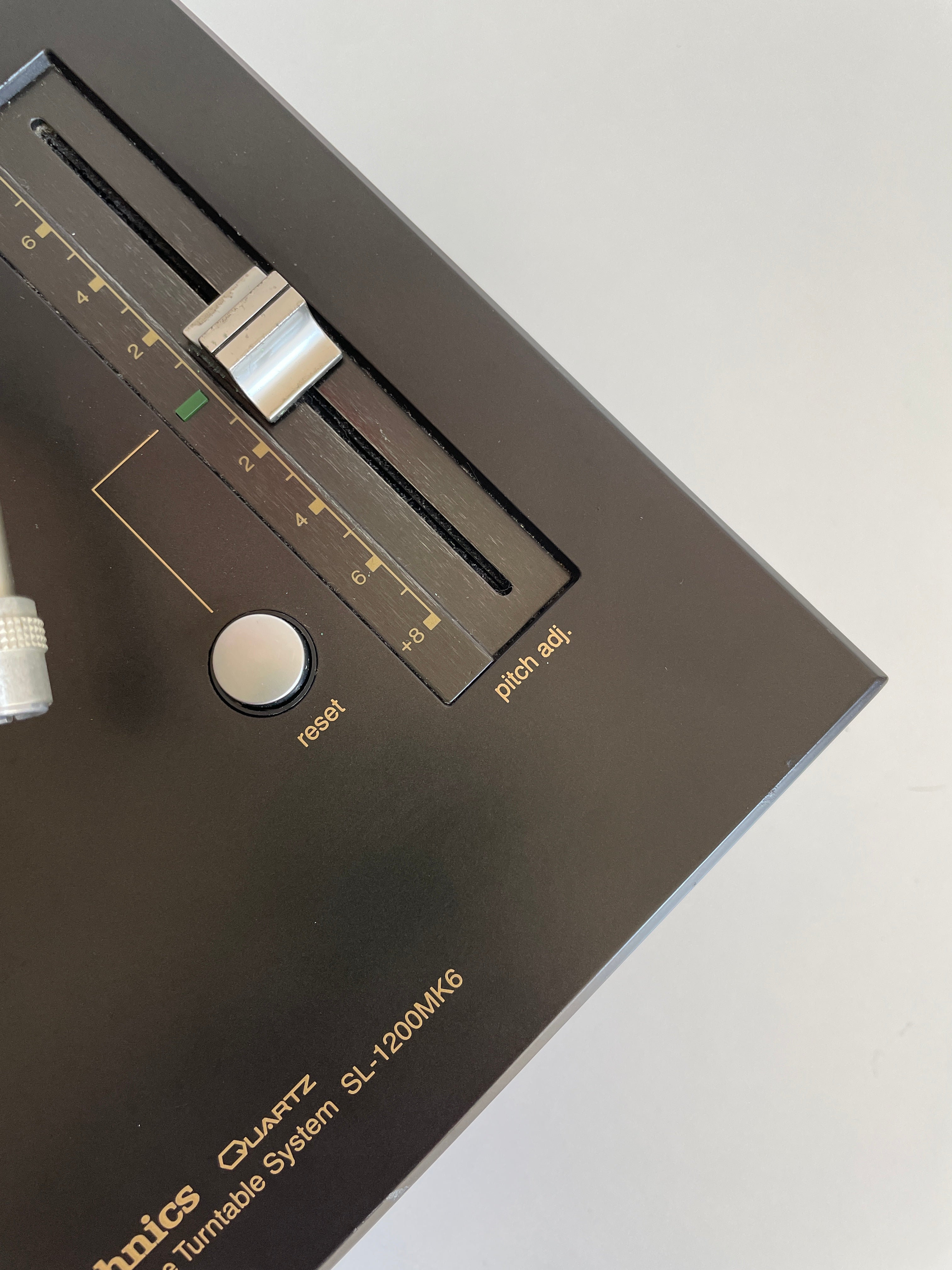 Close-up of a vintage audio equipment component with brand name on a light gray background