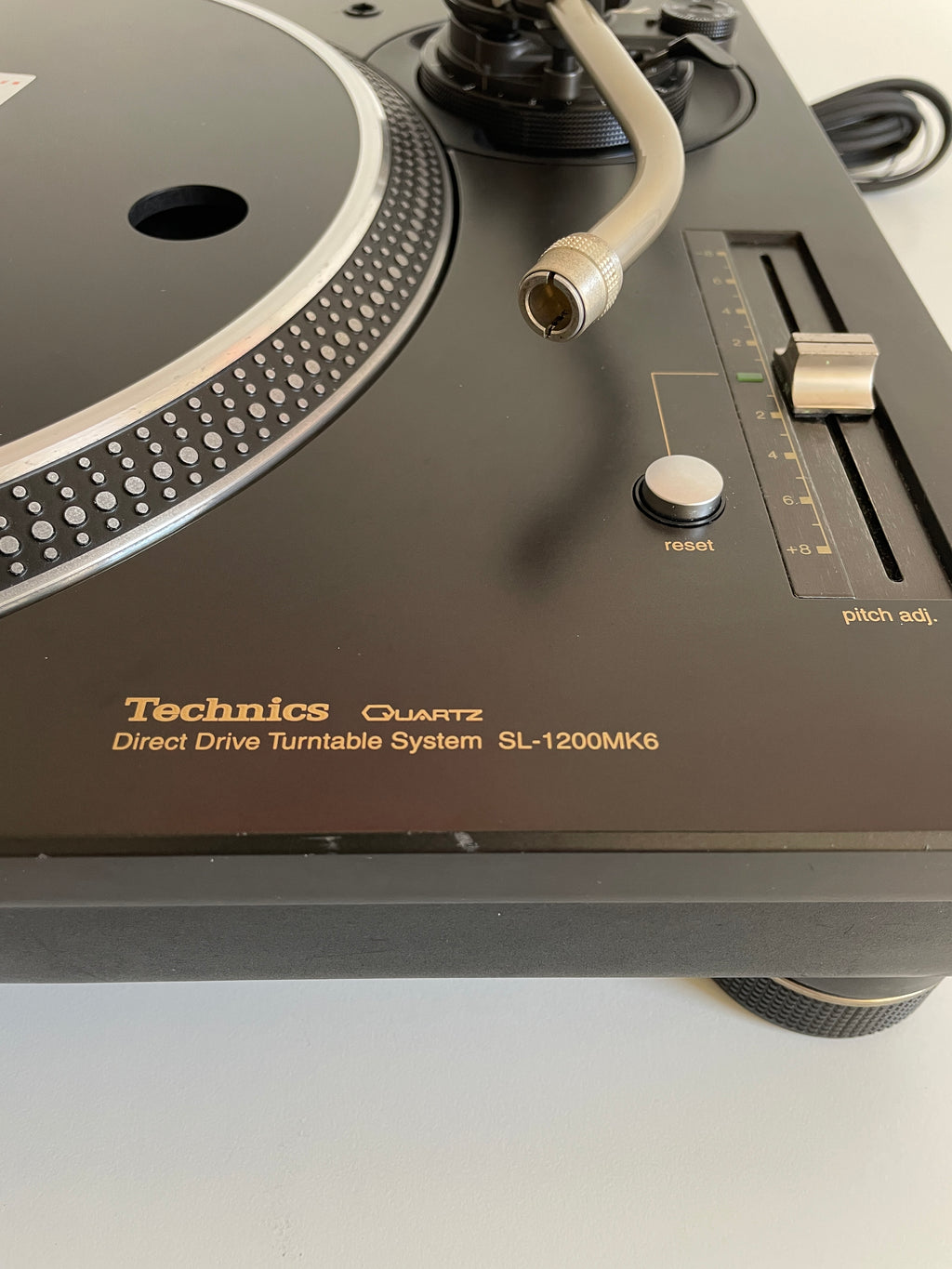 Close-up of a Technics SL-1200MK6 turntable on a white background