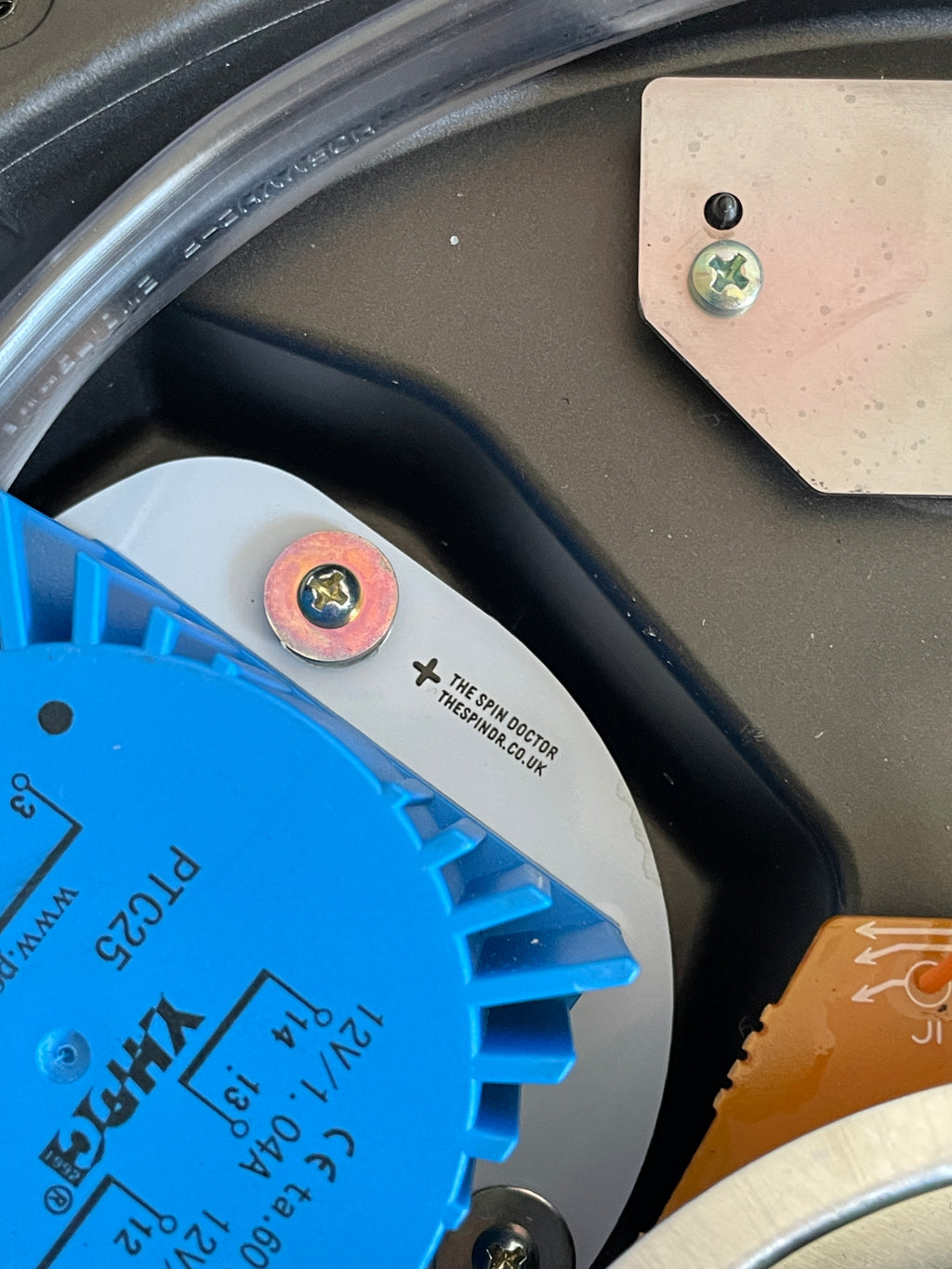 Close-up of a blue mechanical component with visible branding and specifications.
