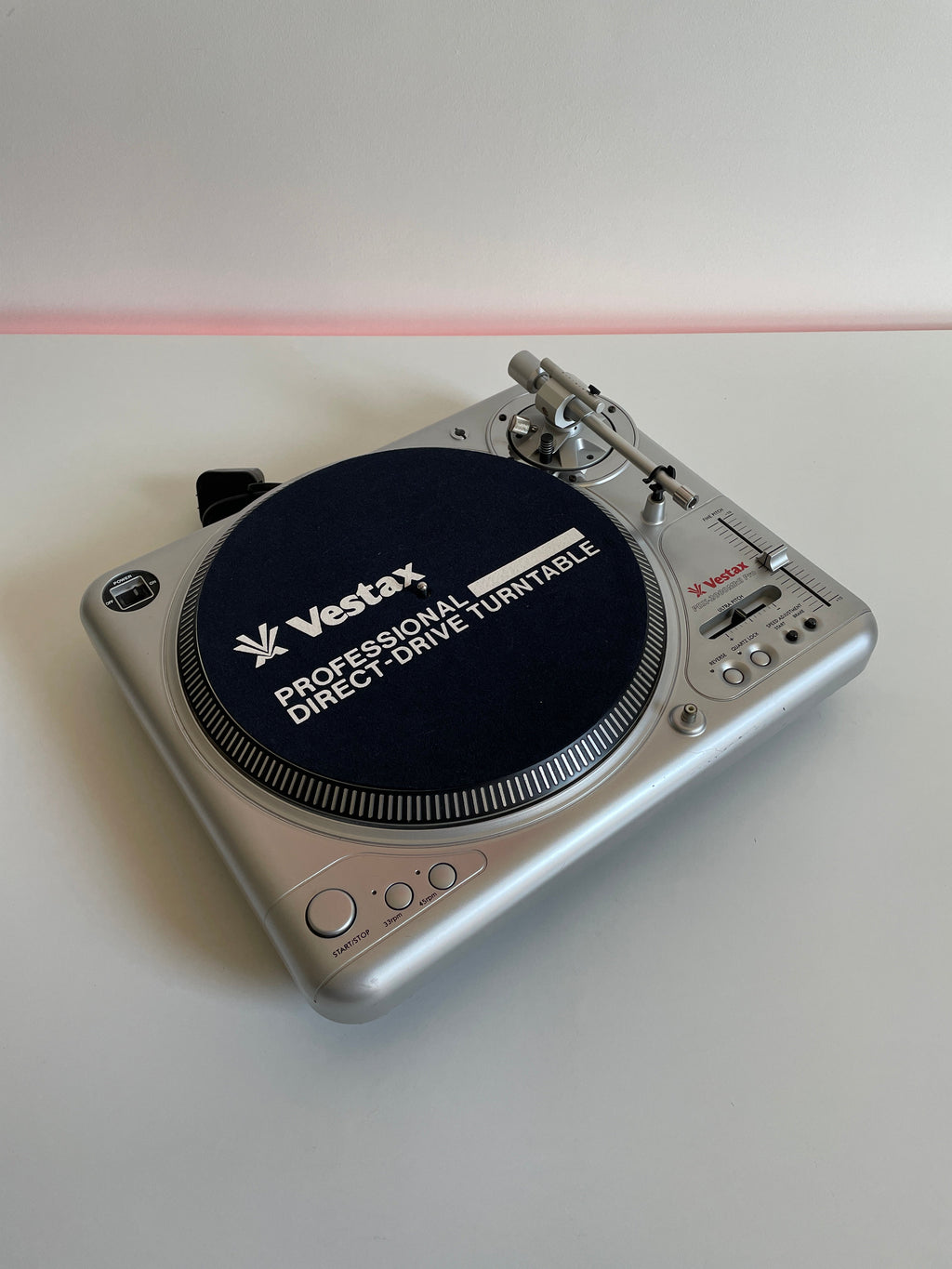 Silver record player on white background