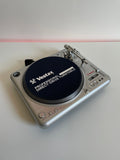 Silver record player on white background