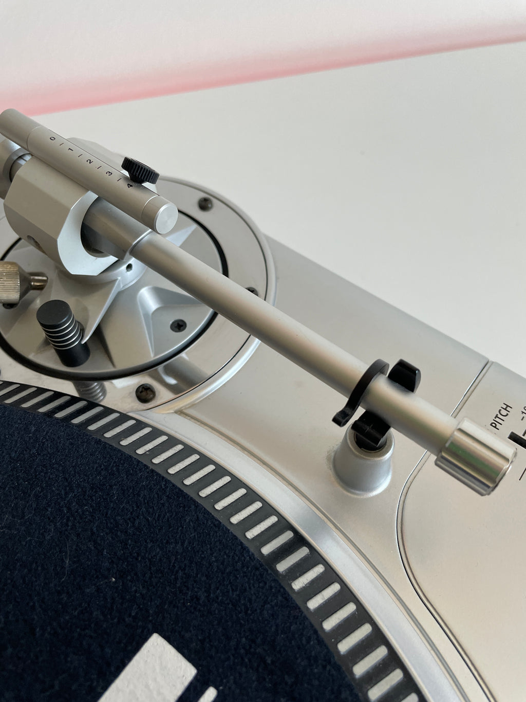 Close-up of a turntable with a focus on the platter and tonearm.