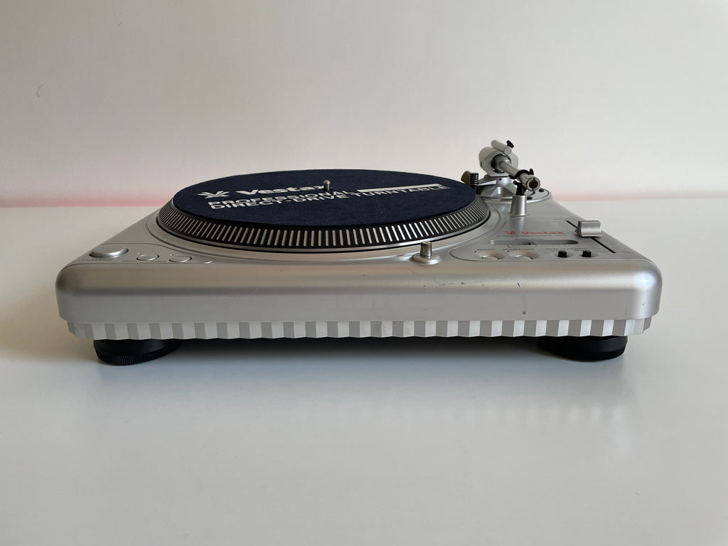 Silver turntable with a blue vinyl record on a white background