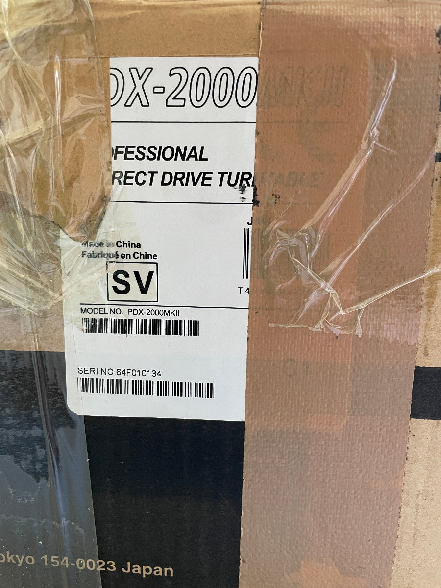 Cardboard box with a label on a textured surface